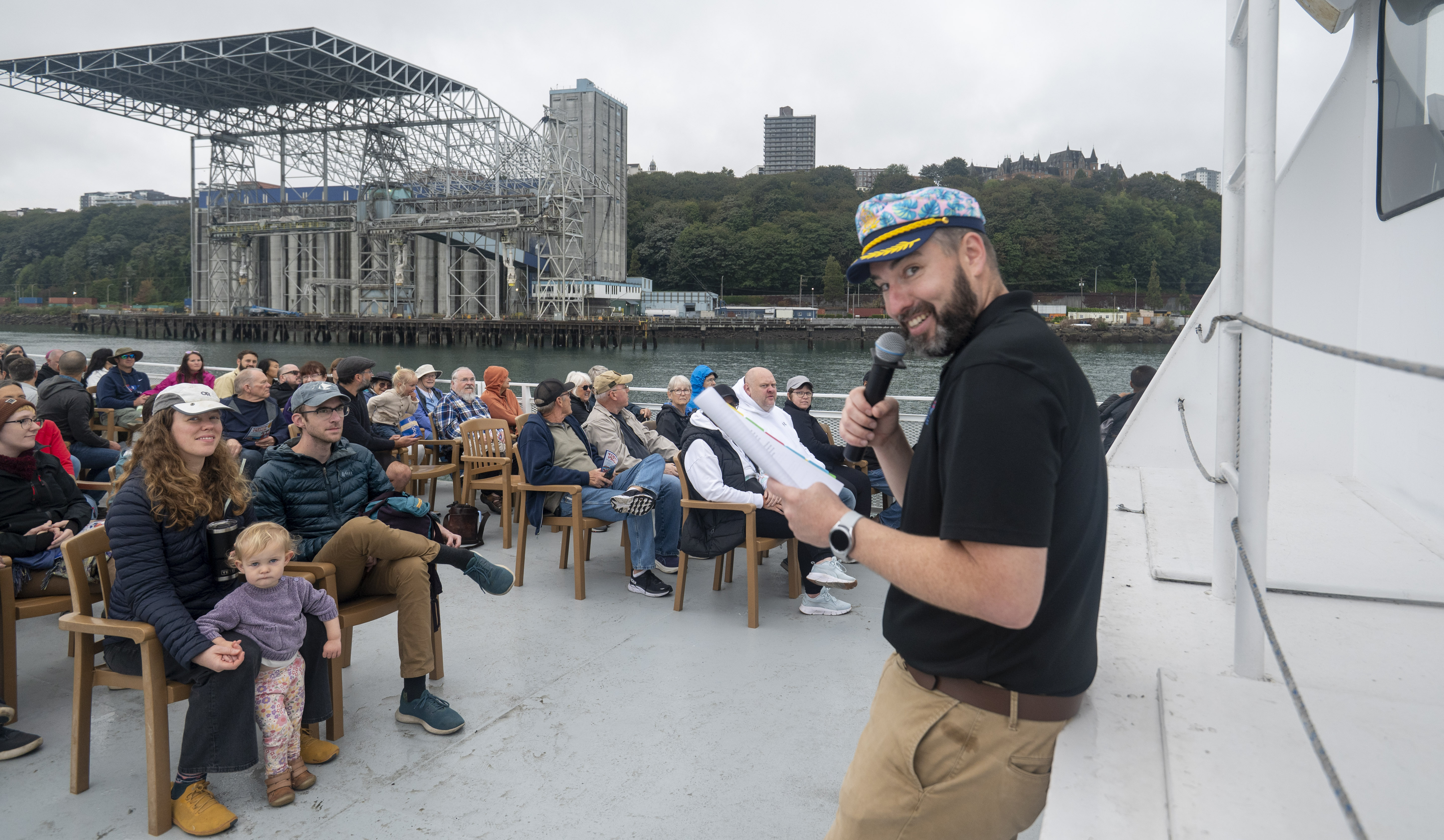 Guests listen to their tour guide as the boat passes TEMCO grain terminal