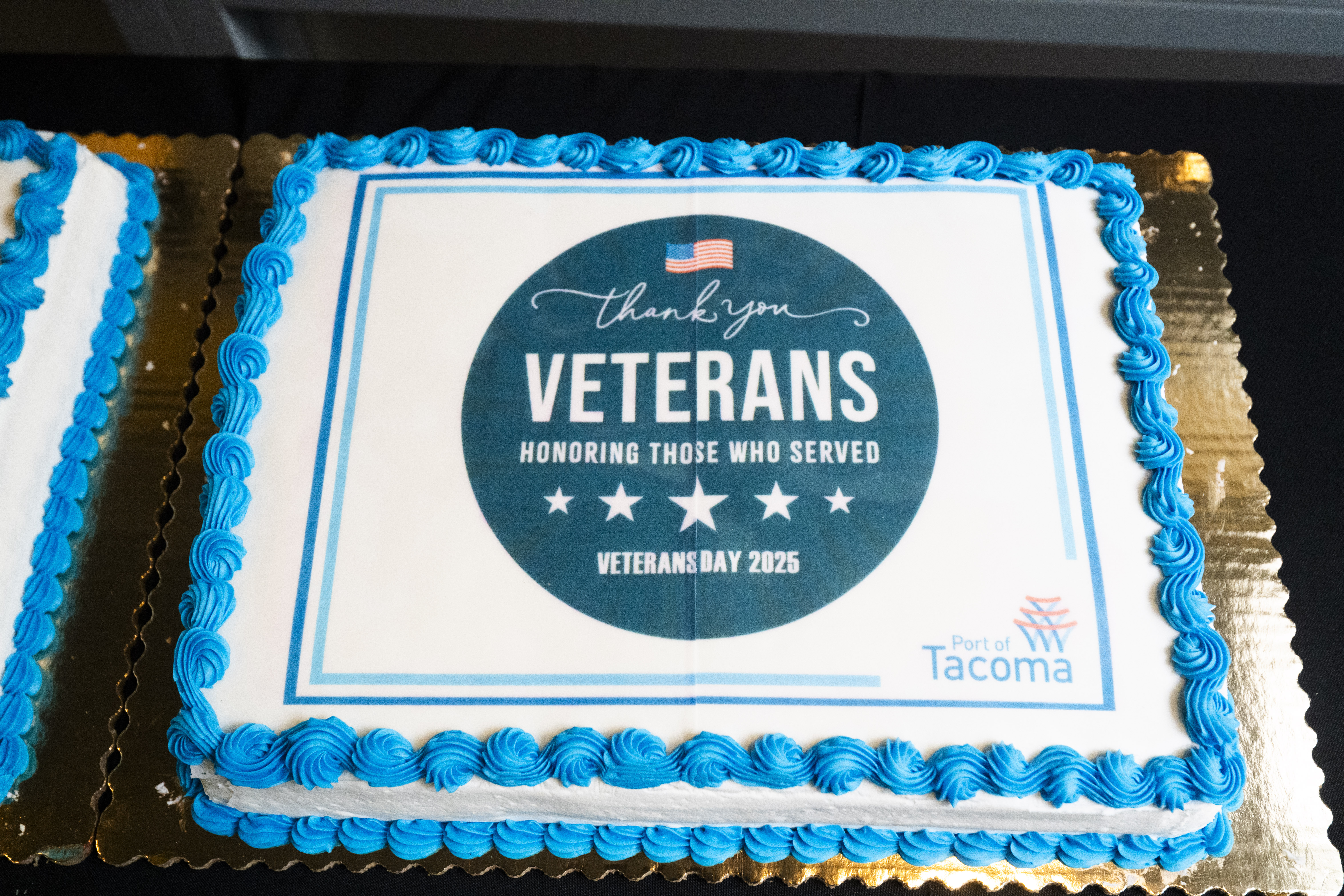 Closeup shot of a cake with blue and white icing and Veterans Day seal