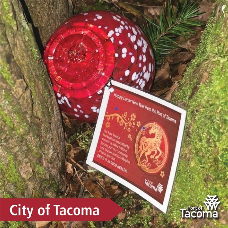 Up close shot of a red Monkeyshines token with the words "City of Tacoma" typed in the corner